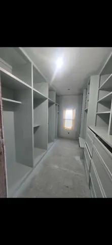 Built-in closet shelving and drawers during residential cabinetry work.