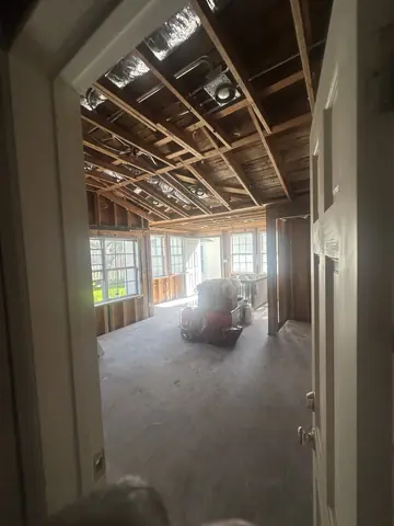 View into the demolition area through an opened interior doorway.