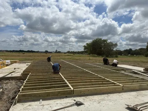 Floor joists being installed above the East Texas foundation.