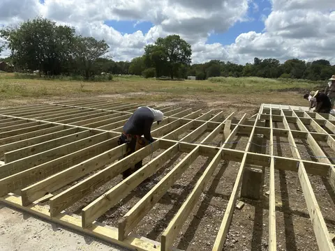Crew setting floor joists at the East Texas project.