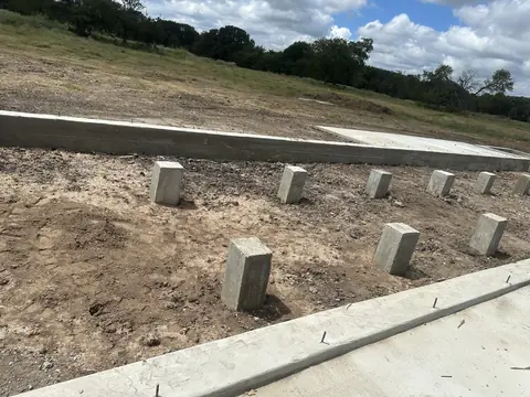 Concrete piers and perimeter foundation before floor framing.