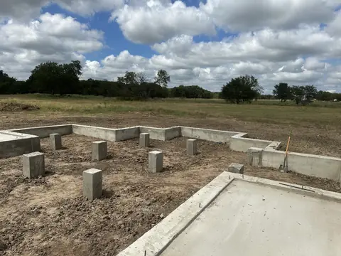Foundation piers arranged across the new-build footprint.