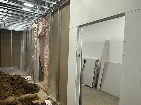 Open wall and floor trench during the fitness build-out.