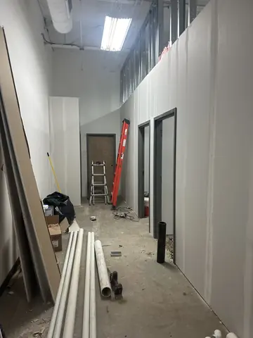 Steel framing along an interior corridor under construction.