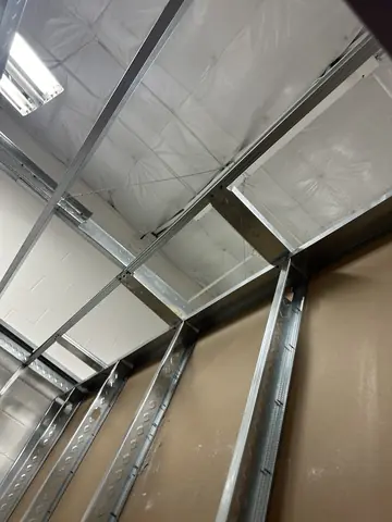 Metal framing beneath the commercial roof structure.