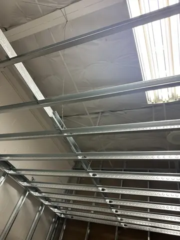 Overhead steel framing during the fitness build-out.