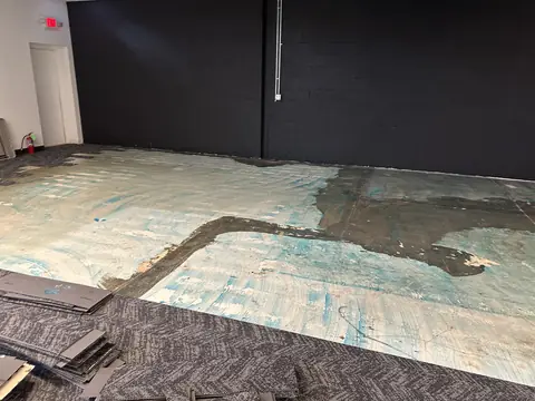 Existing floor finishes removed during preparation for the build-out.