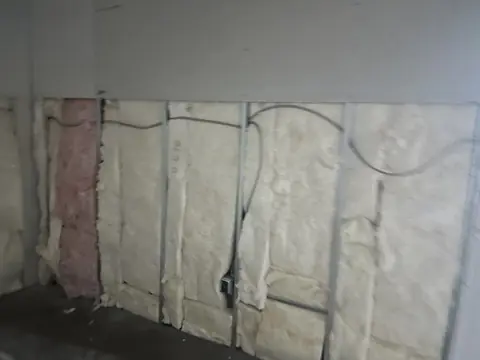 Insulation and wall cavities exposed before finishing.
