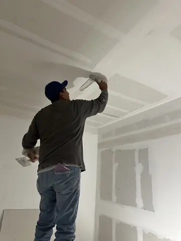 Ceiling finishing in progress in the commercial interior.