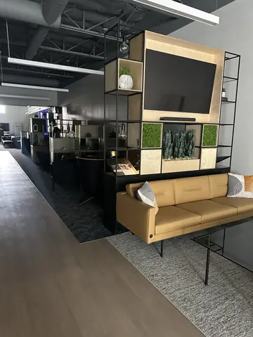 Wood-clad media unit and lounge seating in the completed build-out.