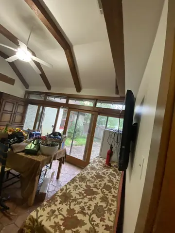 Painted ceiling and exposed wood beams across the living area.