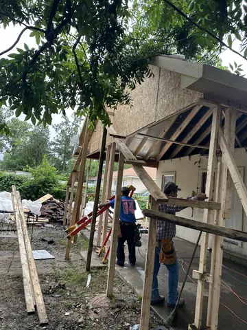 Framing and temporary supports beside the residential addition.