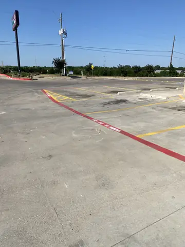 New parking markings and a red fire lane across the commercial lot.