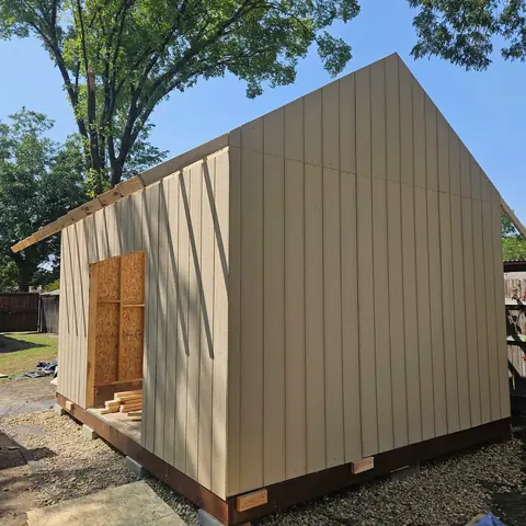 Board-and-batten siding installed around the storage building.
