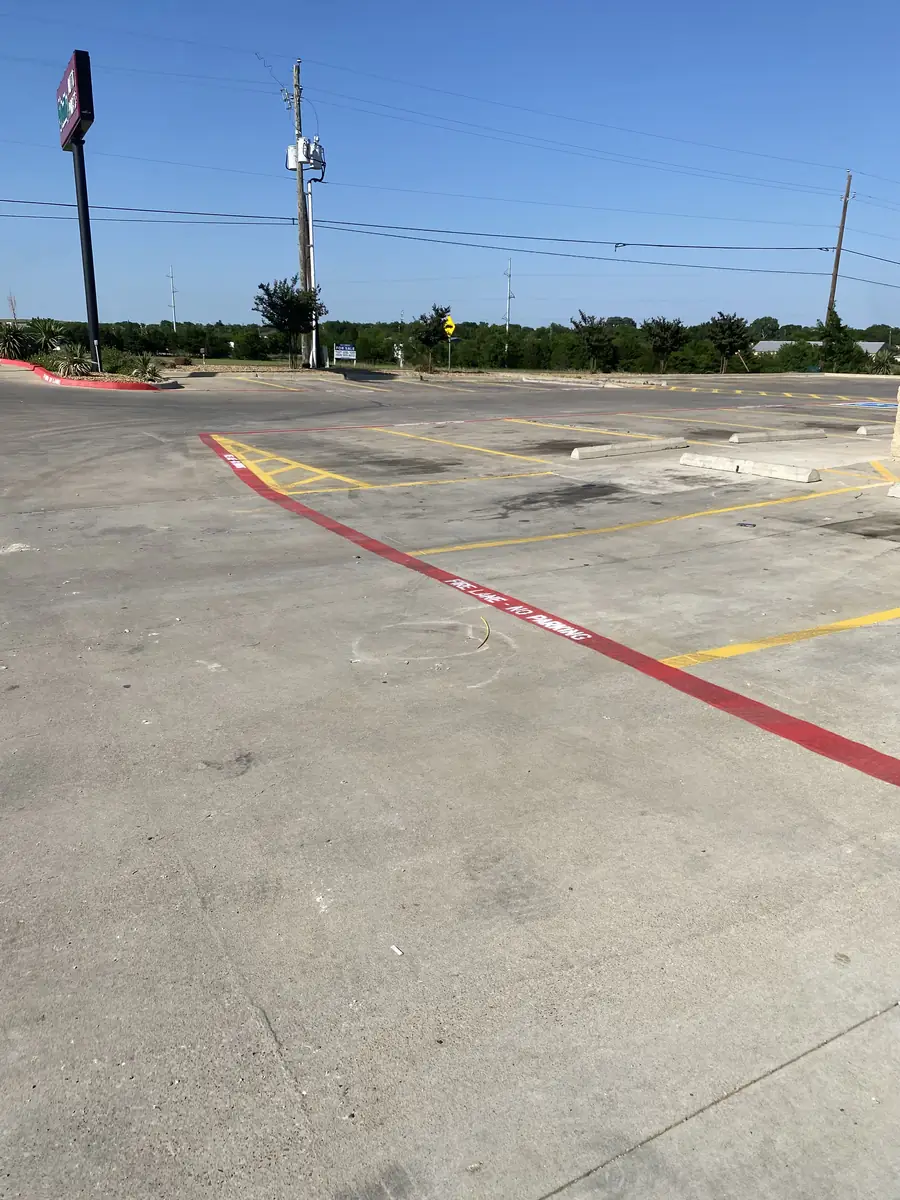 Commercial parking lot with new striping and a marked red fire lane