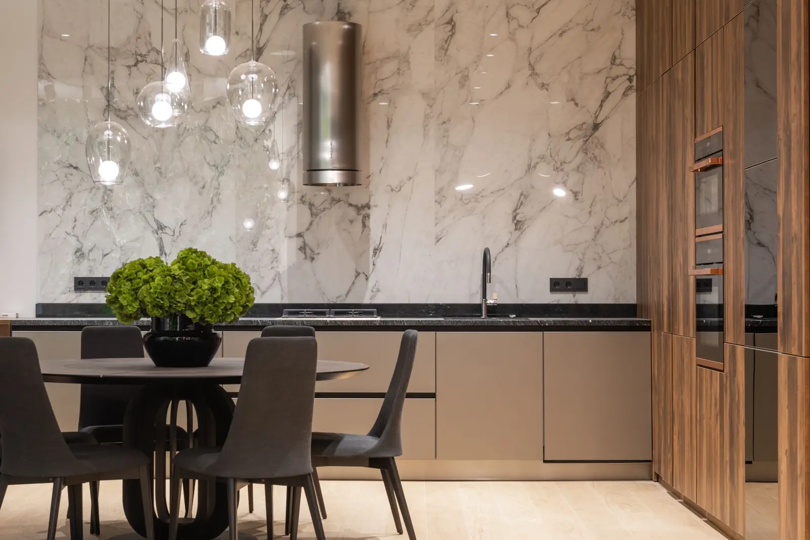 A bright, modern kitchen with a marble backsplash, walnut cabinetry, and a dining area