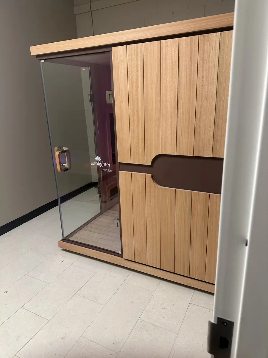 Warm wood-slat accent wall and tile flooring in the finished commercial interior