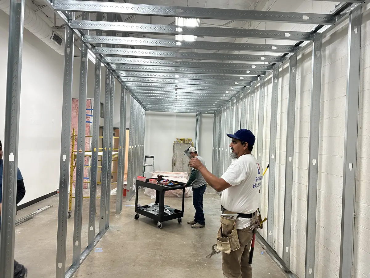 Steel-stud framing during the early phase of a commercial fitness build-out in DFW