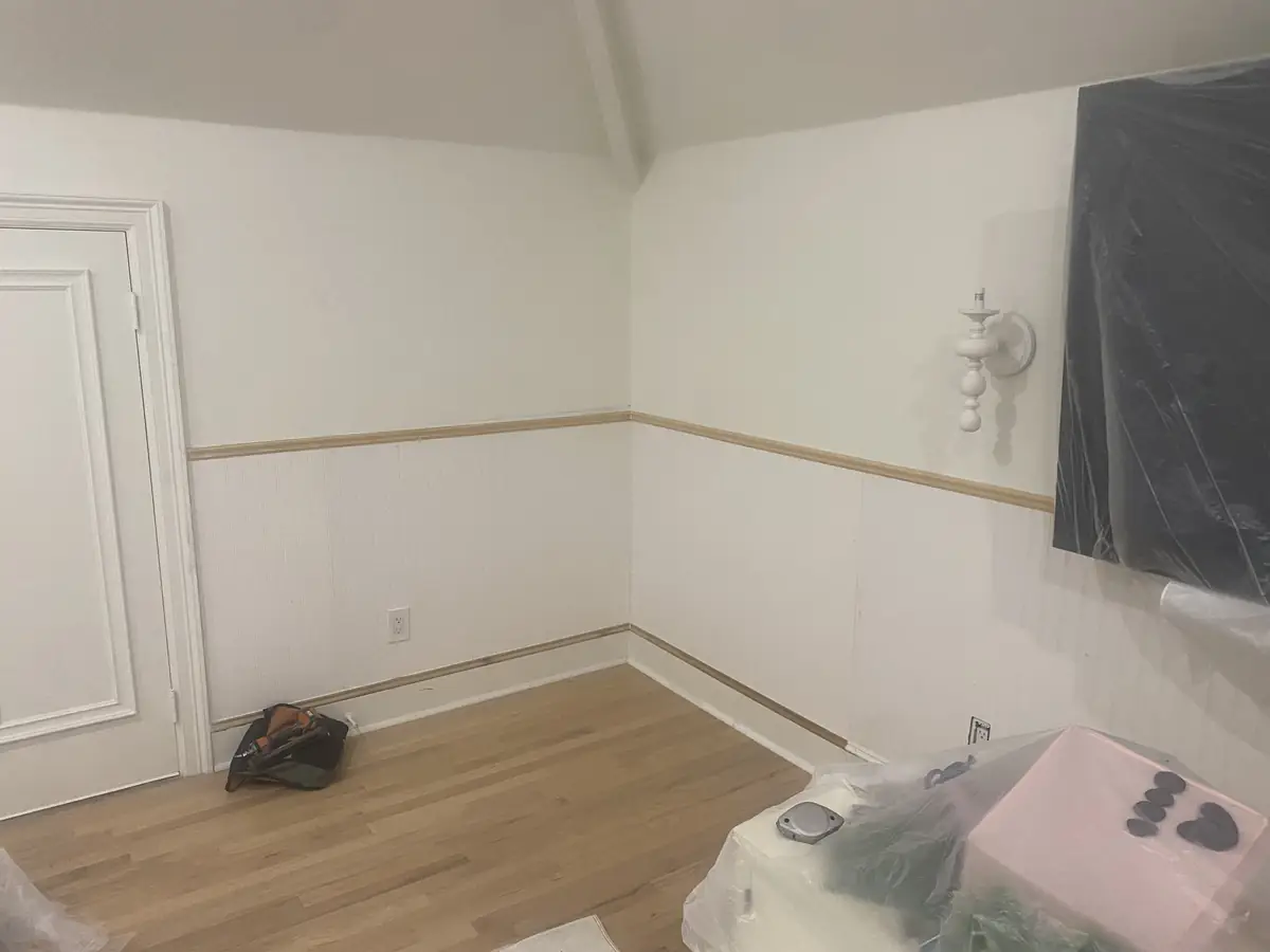 Residential room with new beadboard wainscoting, chair rail, and wood flooring